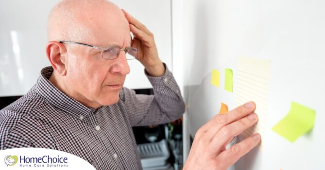 A senior looks at a board confused, representing one of the potential signs of dementia.