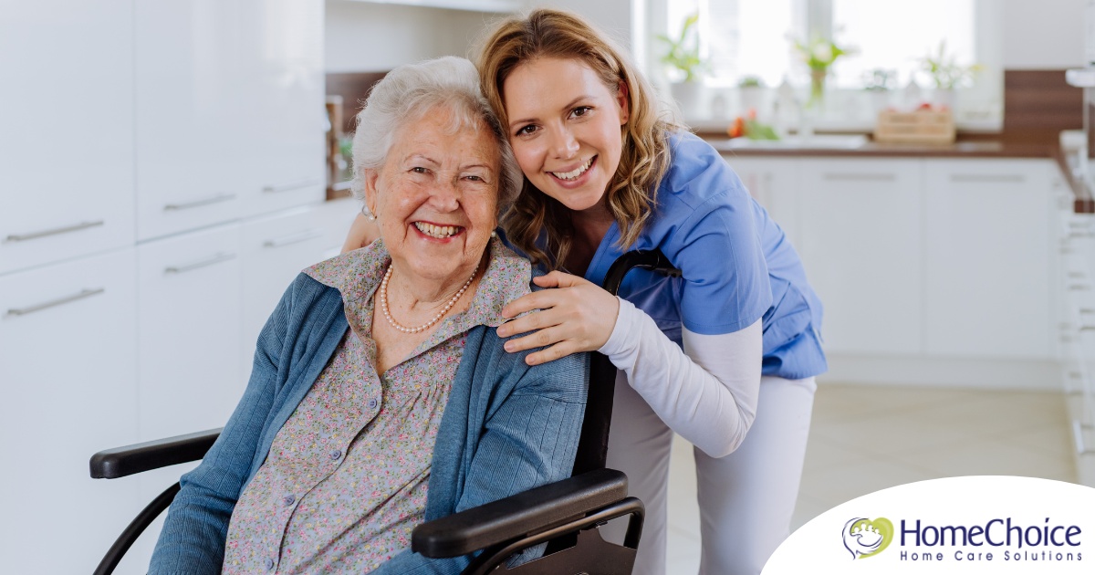 A caregiver enjoys her job as she smiles with a happy client representing the joy that can come from a home care career.